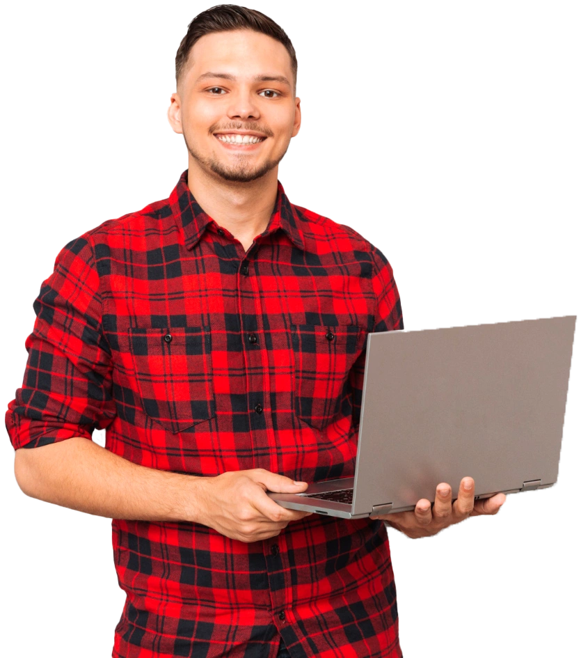 A smiling man holding a laptop.